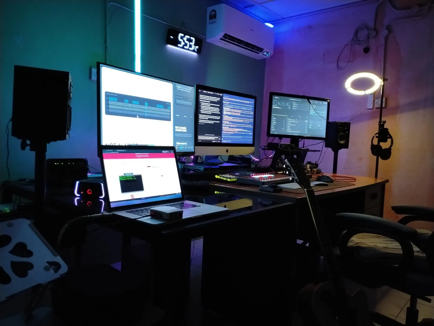 Zaid's studio in Sri Aman: four screens, editing desk, Mac and Linux machines